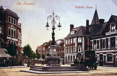 The fountain, Enfield Town
Looking east. Two horses, harnessed to a vehicle, are drinking at a trough beside the fountain. The Nag's Head public house is behind them on the right.
Keywords: fountains;postcards;roads and streets;horse-drawn vehicles