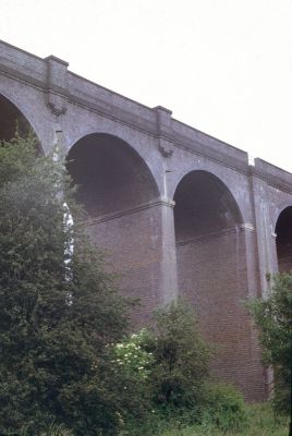 Rendlesham viaduct 
When the Great Northern Railway was extended from Grange Park to Cuffley in 1910, the 75-feet high, fourteen arch, Rendlesham viaduct was constructed across the valley between Gordon Hill and Crews Hill.

Comment from Elaine Jordan, 2011-07-10: "As a child in the 1060s my mother used to take my brother and me to "Hilly Fields" where we would play for hours. At that time there were just grass hills to the "fourteen arches" where my brother and I would run under them in turn shouting to hear the echo. When I went back recently 43 years later, the arches could barely be seen... Hidden by trees over the years... Glad they are still in one piece, sad because I have no pictures of how they looked in the 60s. My aunt who walked the dog there for years never knew the arches were there, said 'Well I've learnt something today and I think the "fourteen arches" are beautiful!!!!' I agree.... Elaine."
