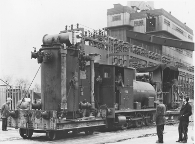 Brimsdown power station: locomotive removing transformer
"Lord Ashfield" fireless locomotive, driver Jim Schooling, removing a transformer. Group I switchgear behind the locomotive, "A" station to the right, rear. Picture taken looking SE; overhead lines in the background.
Keywords: rail transport;