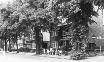 Cecil Road houses
View from the east, taken from the corner of Raleigh Road. On the extreme right is the exit from the borough car park, once Allen Fairhead's builder's yard. Cecil Road at one time extended from London Road up to the wall of the Town Park; beyond, there was the estate of Chase Side House. The newer houses in Cecil Road were not built until after the Council bought the estate in 1901-02 and Cecil Road was extended and the Town Park formed as Enfield's first park. Chase Side House stood approximately on the site of the library. For many years the drive to the house from Church Street was discernible across the grass of the library green.
