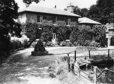 Portcullis Lodge with a corner of the New River Loop
Demolished by Enfield Council in 1968. The house once belonged to Sir Alfred Somerset, the master of the Enfield Chase pack of staghounds, who lived at Enfield Court, now the school. Portcullis Lodge was so named because a portcullis was the badge of his family - [i]Fighting for the future, p.51-52.[/i] 

[i]Reproduction right held by Enfield Local Studies Library and Archive.[/i]
Keywords: gardens;houses;New River Loop;railings;demolished buildings