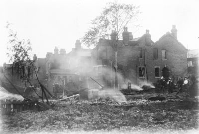 Fire, Chase Side, 18th July 1911
[i]Comment by P Cracknell, 2014-04-01:[/i] The photo shown looks south across the remains of the yard behind 122 Chase Side, looking towards 23 Holtwhite Avenue which was gutted by the fire. 

[i]Comment by Daren Gordelier, 2014-05-05:[/i] Damage caused by the fire on 18th July 1911. 
Keywords: demolished buildings;fires