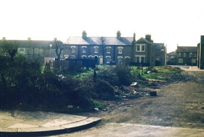 Gordon Road and Halifax Road
Slide has note which appears to read "Off Gordon Lane".  Gordon Lane is the previous name of the east end of Gordon Road, where it meets Baker Street.
[i]Comment from Daren Gordelier, 2014-02-16: "No 101 Gordon Road stands on this unmade road. A pathway through on the right of this picture remains leading to Halifax Road, the houses are nos. 79-87 Halifax Road, Bellamy Road then links to Manor Road which are the houses in the distant right."[/i]
Keywords: roads and streets;houses
