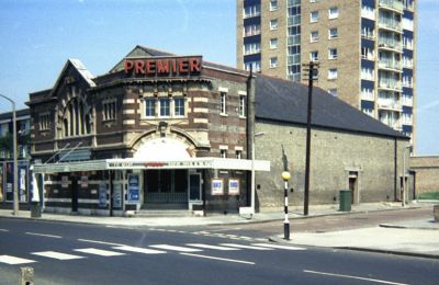 Premier Cinema, 1969
On the corner of Hertford Road and Eastfield Road, at 485 Hertford Road, Enfield, EN3 5XH. Built by Mr W. Grenfell, a local builder, the Premier Cinema opened on 17th January 1921 with "Wolves of the Night" starring William Farnum.

By 1932, it was being operated by Ben Jay, who also operated the Corner Cinema, South Tottenham. In 1938, it was taken over by Davies Cinemas Ltd.

The Premier Cinema was closed on 19th April 1961. It was converted into a bingo club, and this was eventually closed in 1985. The building was quickly demolished and housing was built on the site. [i] - [Information from: [url]http://cinematreasures.org/theaters/29472[/url]][/i]. Photograph by Kevin Wheelan. For more details and pictures see [url]http://www.eastend-memories.org.uk/excelsior/excelsior_4.htm[/url]

Keywords: 1960s;cinemas;demolished buildings;bingo halls