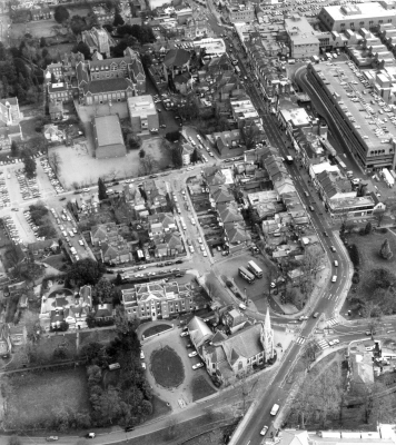 Aerial view of Enfield Town
Junction of Church Street and Cecil Road in the foreground. Shows Church Street looking east and Palace Gardens car park. Little Park, the Tudor Room and the public offices at 1 Gentleman's Row in the left foreground; Grammar School and St Andrew's Church in the left background.
Keywords: roads and streets;aerial;buses;FP2