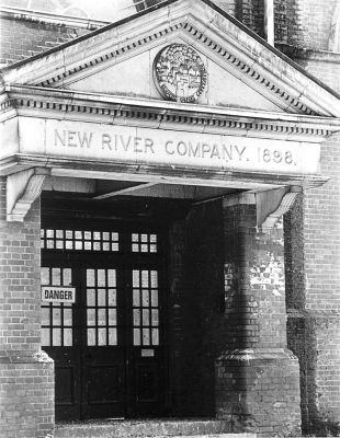 Former pumping station, Whitewebbs Lane, 1983
Now the Whitewebbs Museum of Transport. The seal of the New River Company on the plaque above the door depicts the 'hand of Providence bestowing rain' upon the city with its motto "et plui super unam civitatem" (and I rained upon one city). 
Keywords: 1980s;plaques;pumping stations;New River;water supply