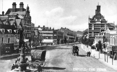 Enfield Town before 1909.
Note on print reads: "The Bailey's family greengrocers' shop was at the corner of Genotin Terrace (north side) and London Road until 1977, when heavy increase in rent closed the business. Note hand ladders for fires between the fountain and Bailey's delivery van."
Keywords: 1900s;horse-drawn vehicles;horses;fountains