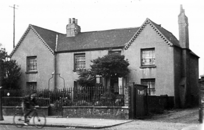 "The Elms", 270 Hertford Road (now demolished)
A gentleman called Henry Parry, member of the Local Board of Health, lived there in 1870-1871.

A note on the back of the print reads: "Home of the Misses E. & G. Watts. "The Elms", 270, Hertford Road. Also owned the corn chandlers shop on the corner of Hertford Road & Carterhatch Lane. Photograph taken in the early 1930's. Said to have been 200 yrs old & thatched at one period."

Accompanied by one page of a manuscript letter, unsigned but sent from Langley, Berks and dated October 21, 1976. The relevant part of this letter reads:

"I enclose the picture of "The Elms" our old house. We do not know why it was so named as we only had a huge sycamore & a few holly trees when we went to live there. The said sycamore was cut down when motor busses [sic.] came along for the first time, maybe a few heads would have been chopped off & left in the garden as the busses had no covered tops at that time. The railings (iron) were taken down in the Second World War to be used for armaments I suppose. We had no say in the matter in spite of their age & interest. The lamp holder in the centre we understood held the only lamp in the street for quite some way. We did not have a lamp as street lamps were in."
Keywords: houses;lamps;street furniture