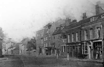 Old Nag's Head pub and Silver Street
From a glass slide. Wording on the second building from the right reads "BARCLAY PERKINS" and "WINE & BRANDY MERCHANT".
Keywords: pubs;roads and streets
