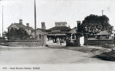 Great Eastern station, Enfield Town, 1910
This was on the site of the present Enfield Town station. It shows a raised clerestory section above the ticket hall which is crowned with ornate iron work. The clerestory section was removed at a later stage of the building's life. This may have been due to rainwater leaking in or a move towards reducing maintenance costs.
Keywords: rail transport;railway stations;postcards