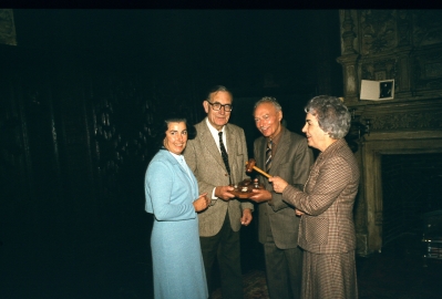 Presentation of gavel and block to EPS
The gavel and block were presented to the Enfield Preservation Society by Mr S. Standbrook at a meeting in the Tudor Room on 8th October 1981. 
Left to right: Irene Smith (Hon. Secretary), Donald Potter (President), Stanley Standbrook (previously licencee of the George Inn, Enfield Town), Carinthia Aburthnot Lane.
Keywords: 1980s;events;FC2;EP1;gavels